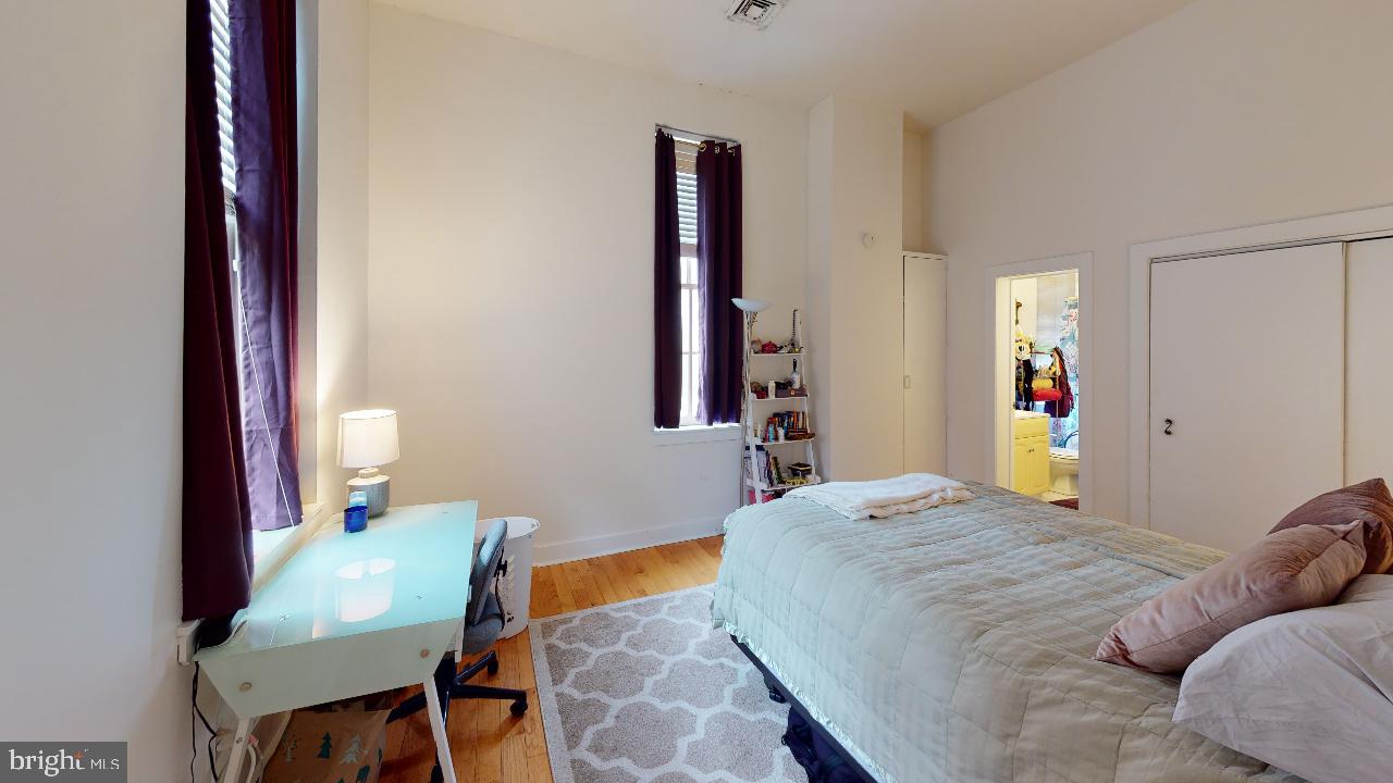 260 South 9th Street, Unit 2F Philadelphia, PA 19107 - Photo 8 of 8 a bedroom with a bed and a chair