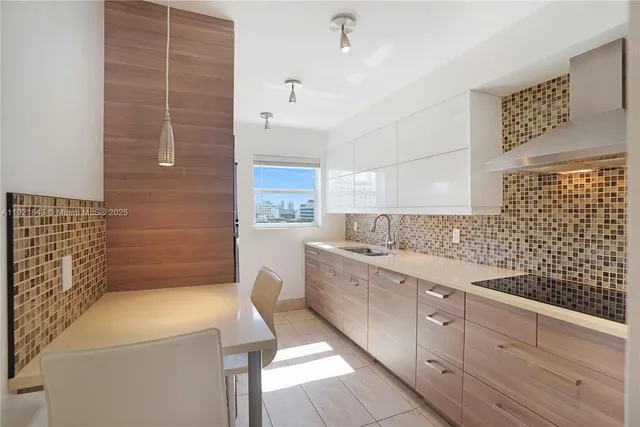 a kitchen with a sink and cabinets