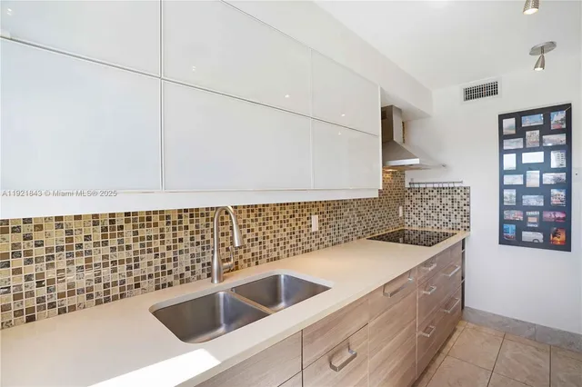 a kitchen with stainless steel appliances a refrigerator and a stove top oven
