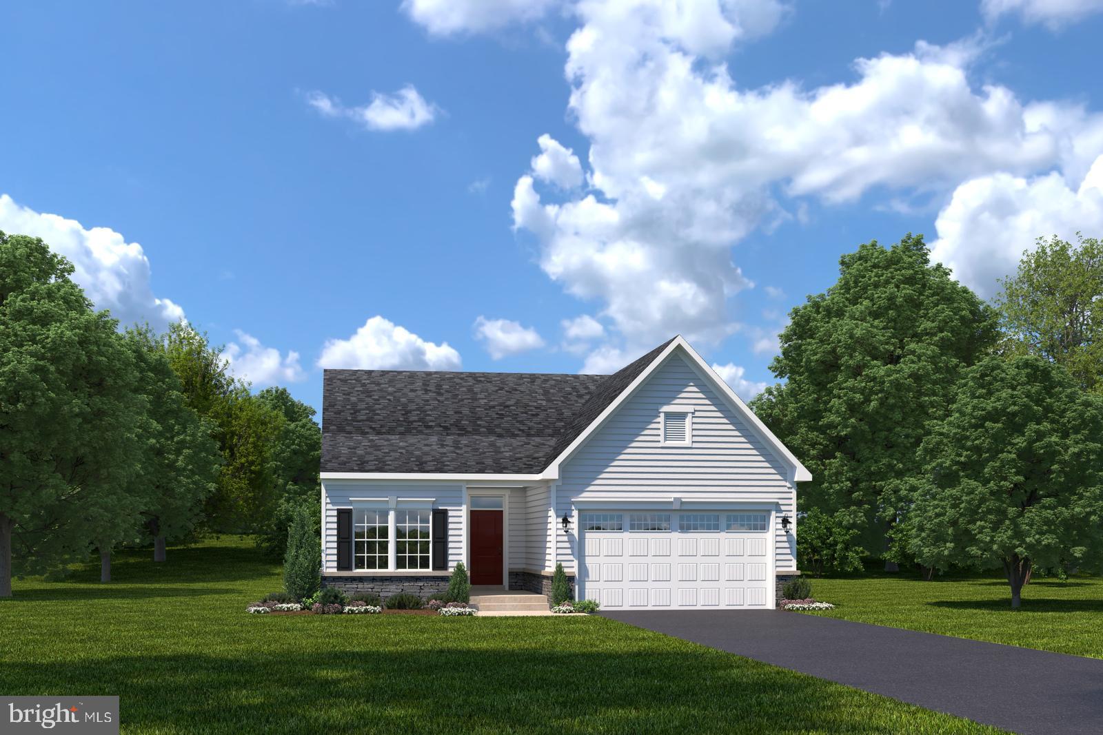 a front view of a house with a garden and trees