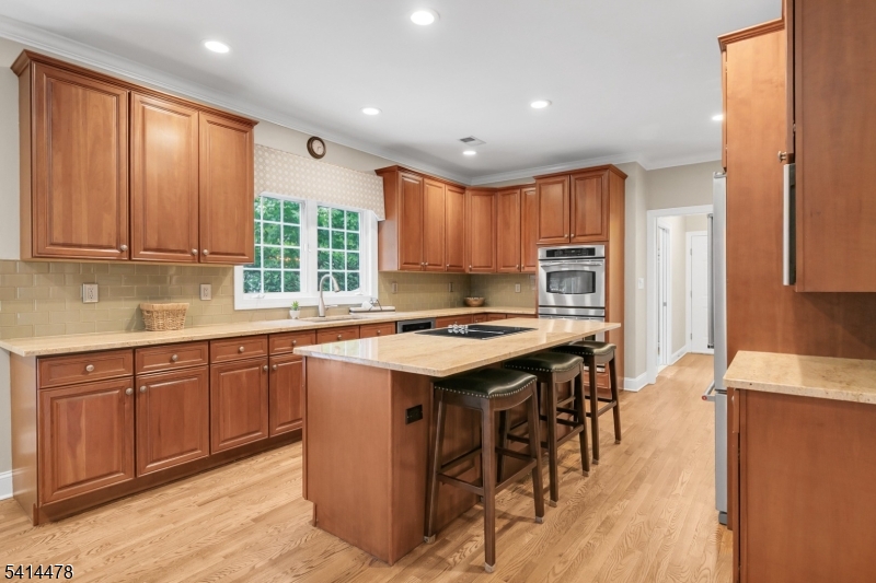 33 St Nickolas Way Bernards, NJ 07920 - Photo 14 of 50 a kitchen with a stove a sink a refrigerator and wooden cabinets