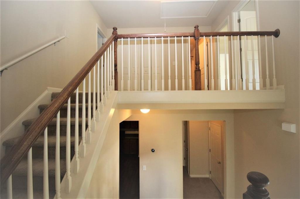316 Alcovy Way Woodstock, GA 30188 - Photo 14 of 28 a view of staircase with railing and white walls