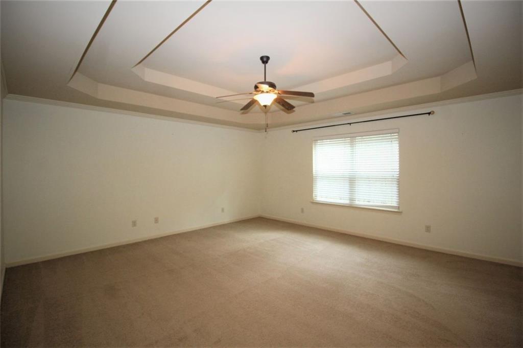 316 Alcovy Way Woodstock, GA 30188 - Photo 15 of 28 an empty room with a window and a ceiling fan