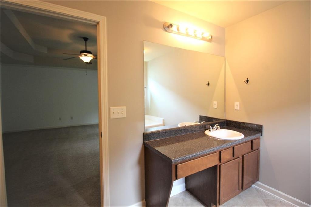 316 Alcovy Way Woodstock, GA 30188 - Photo 17 of 28 a bathroom with a sink vanity and a mirror