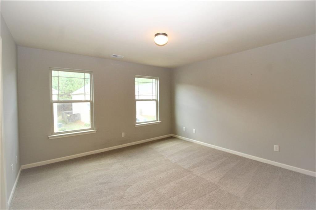 316 Alcovy Way Woodstock, GA 30188 - Photo 24 of 28 an empty room with windows