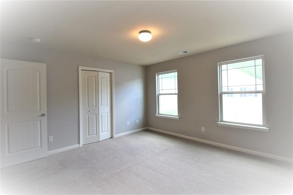 316 Alcovy Way Woodstock, GA 30188 - Photo 25 of 28 an empty room with windows and closet
