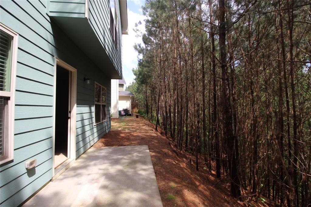 316 Alcovy Way Woodstock, GA 30188 - Photo 27 of 28 a view of a pathway of a house with backyard