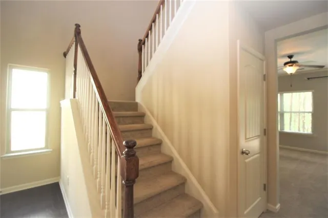 a kitchen with granite countertop wooden cabinets and a stove top oven