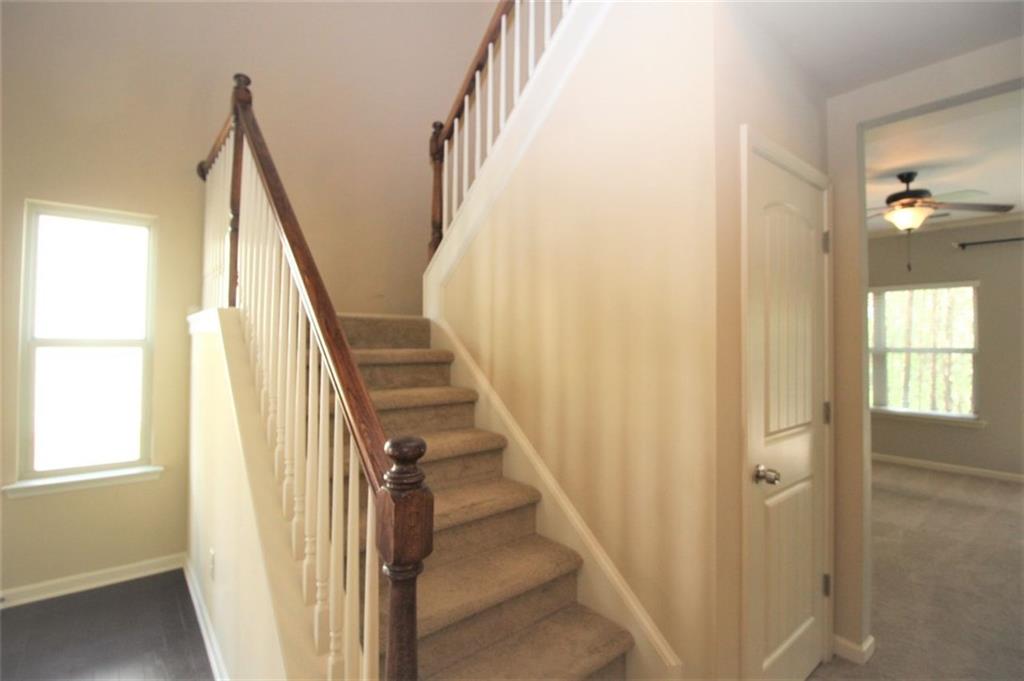316 Alcovy Way Woodstock, GA 30188 - Photo 8 of 28 a view of staircase with wooden floor and stairs