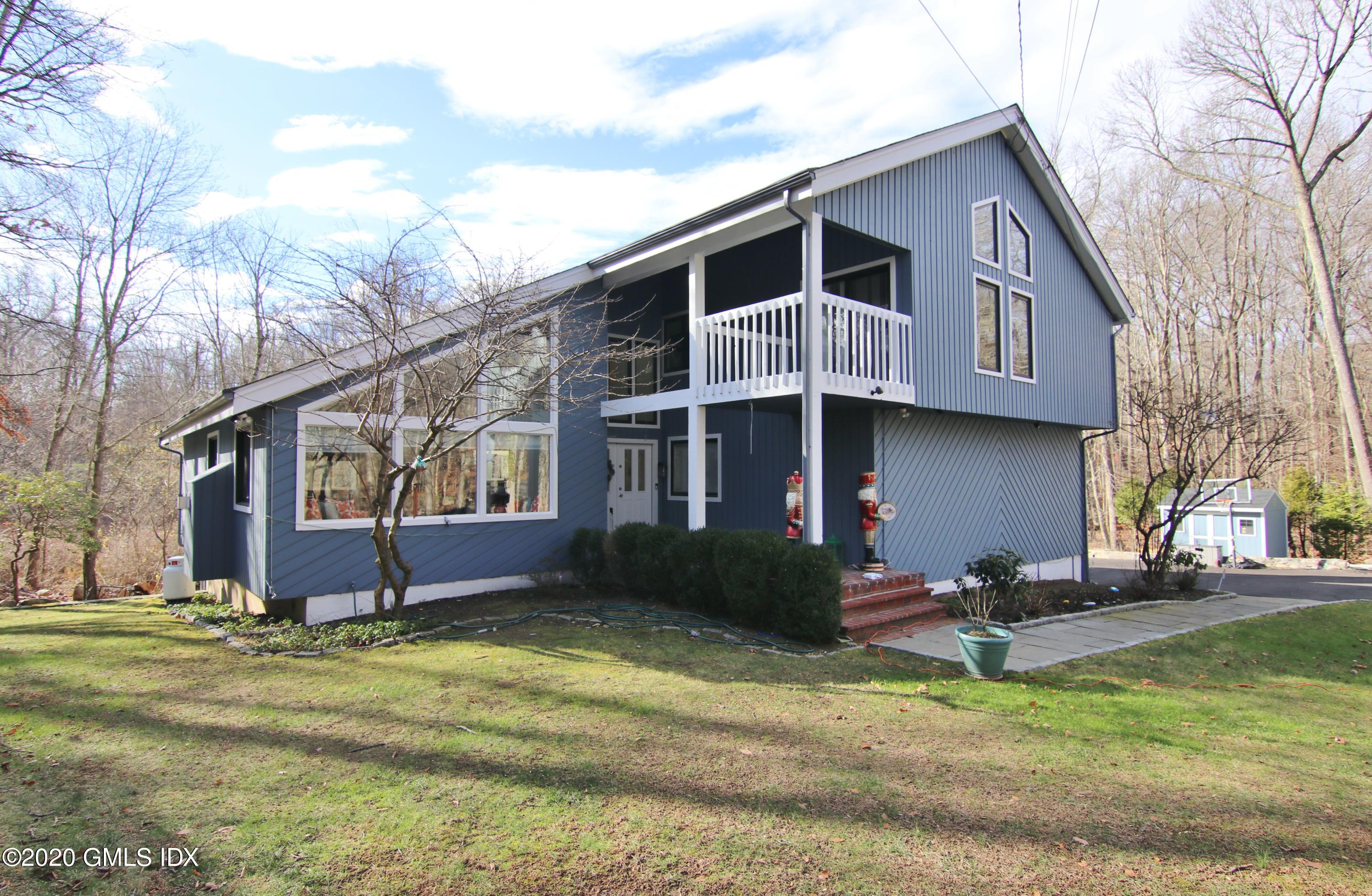 102 Gun Club Road Stamford, CT 06903 - Photo 1 of 41 a front view of a house with a yard