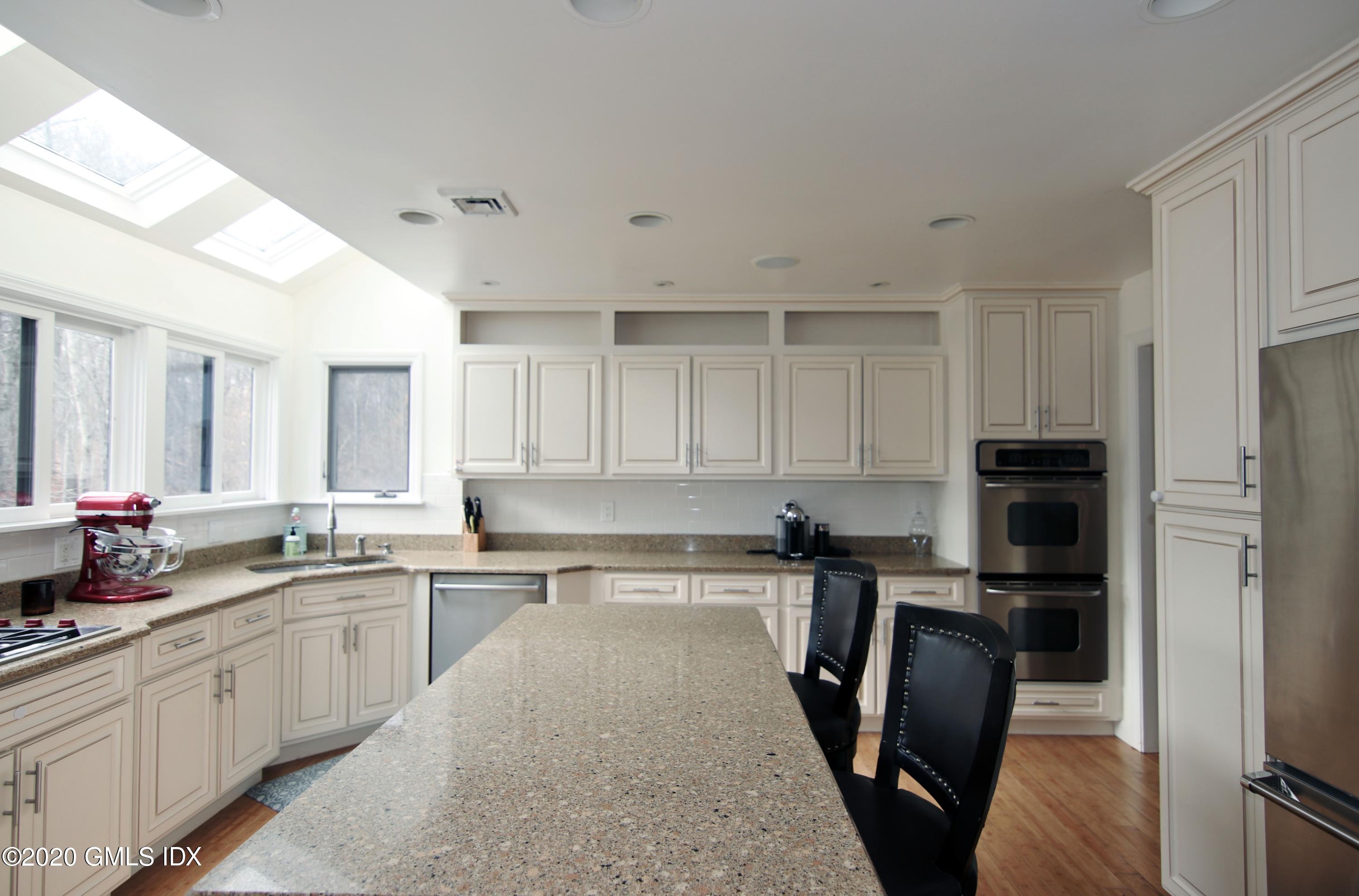 102 Gun Club Road Stamford, CT 06903 - Photo 11 of 41 a kitchen with a sink a counter top space stainless steel appliances and cabinets