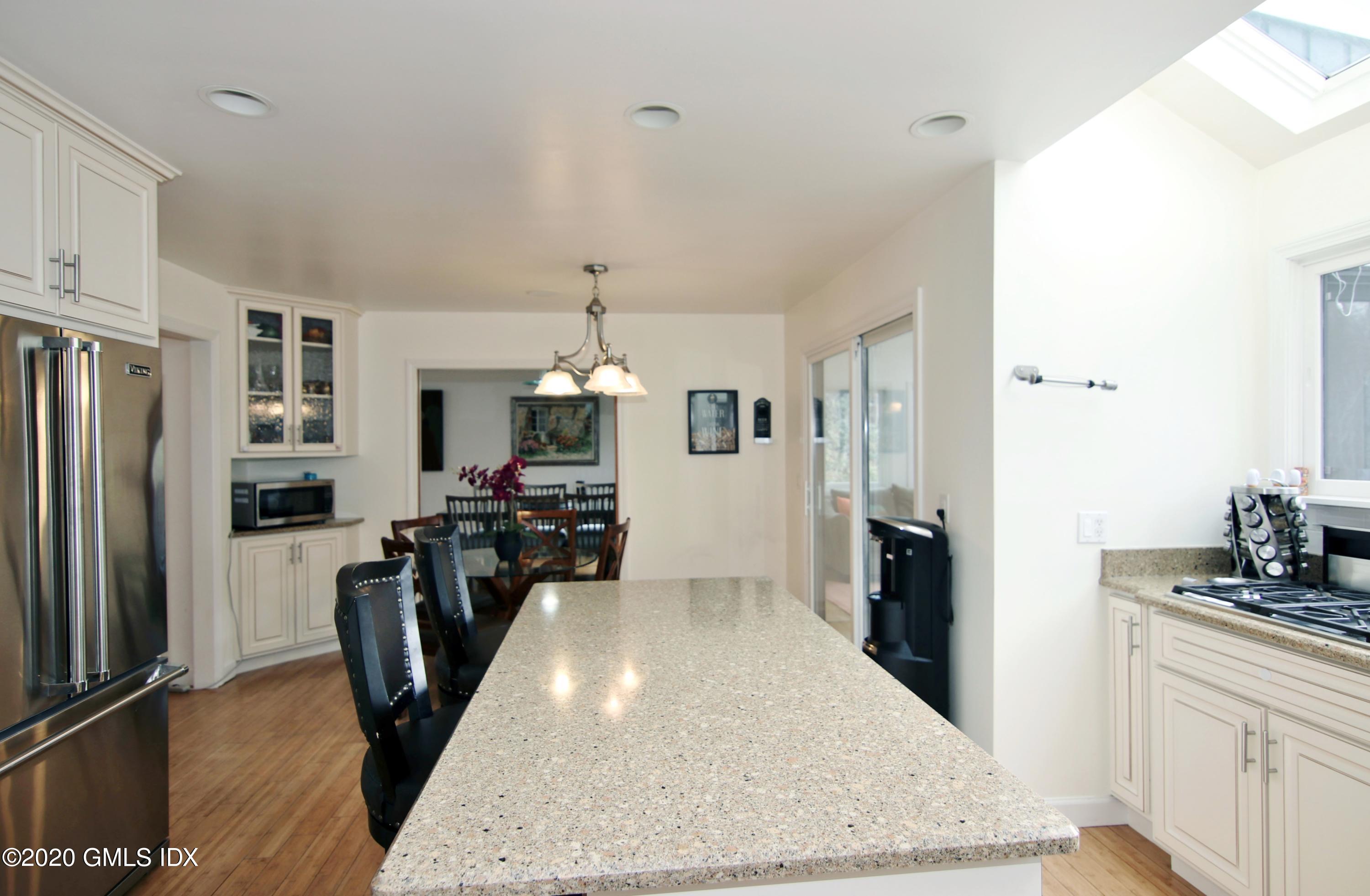 102 Gun Club Road Stamford, CT 06903 - Photo 14 of 41 a kitchen with stainless steel appliances granite countertop a refrigerator and stove