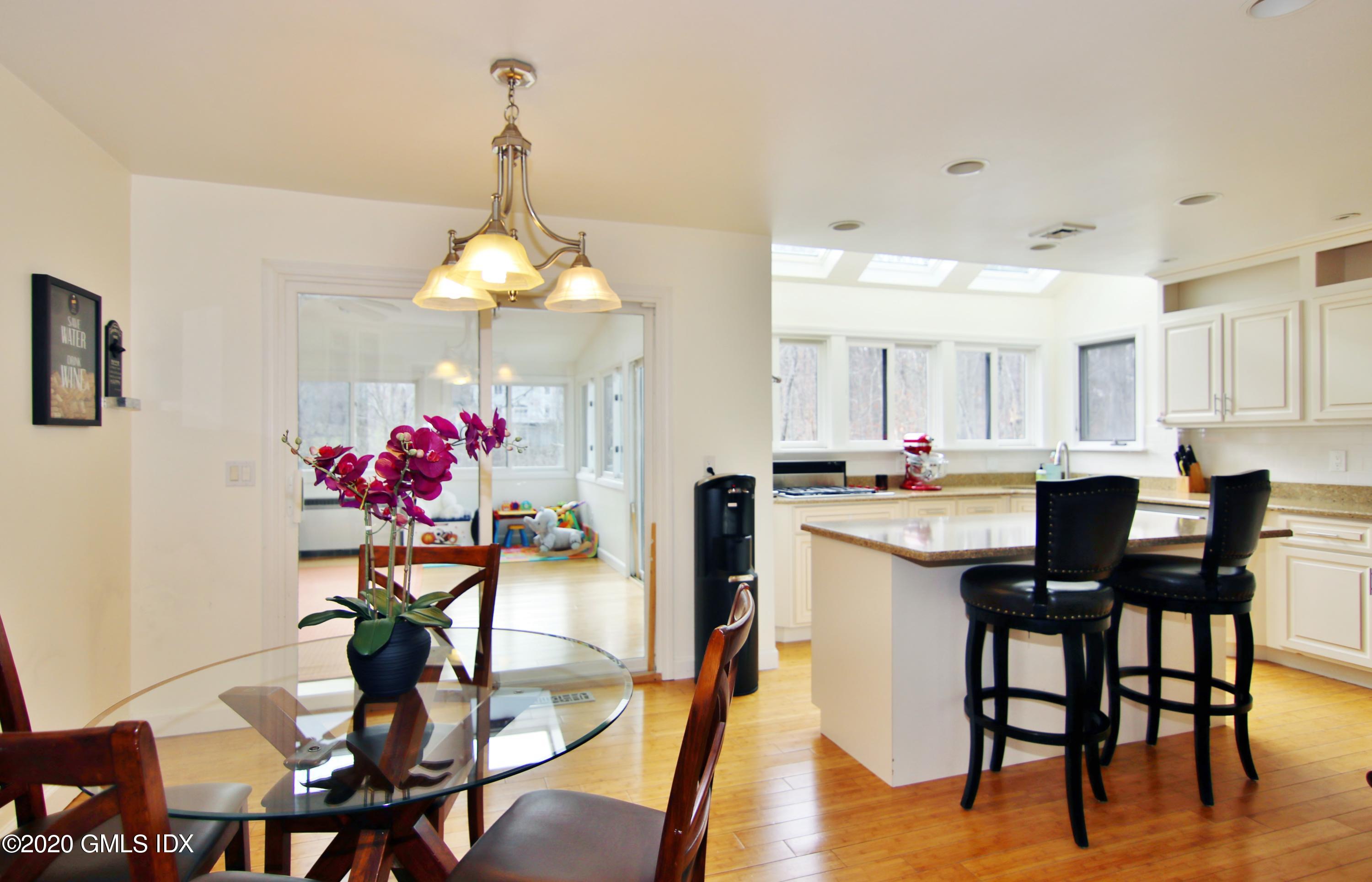 102 Gun Club Road Stamford, CT 06903 - Photo 15 of 41 a view of a dining room with furniture and wooden floor