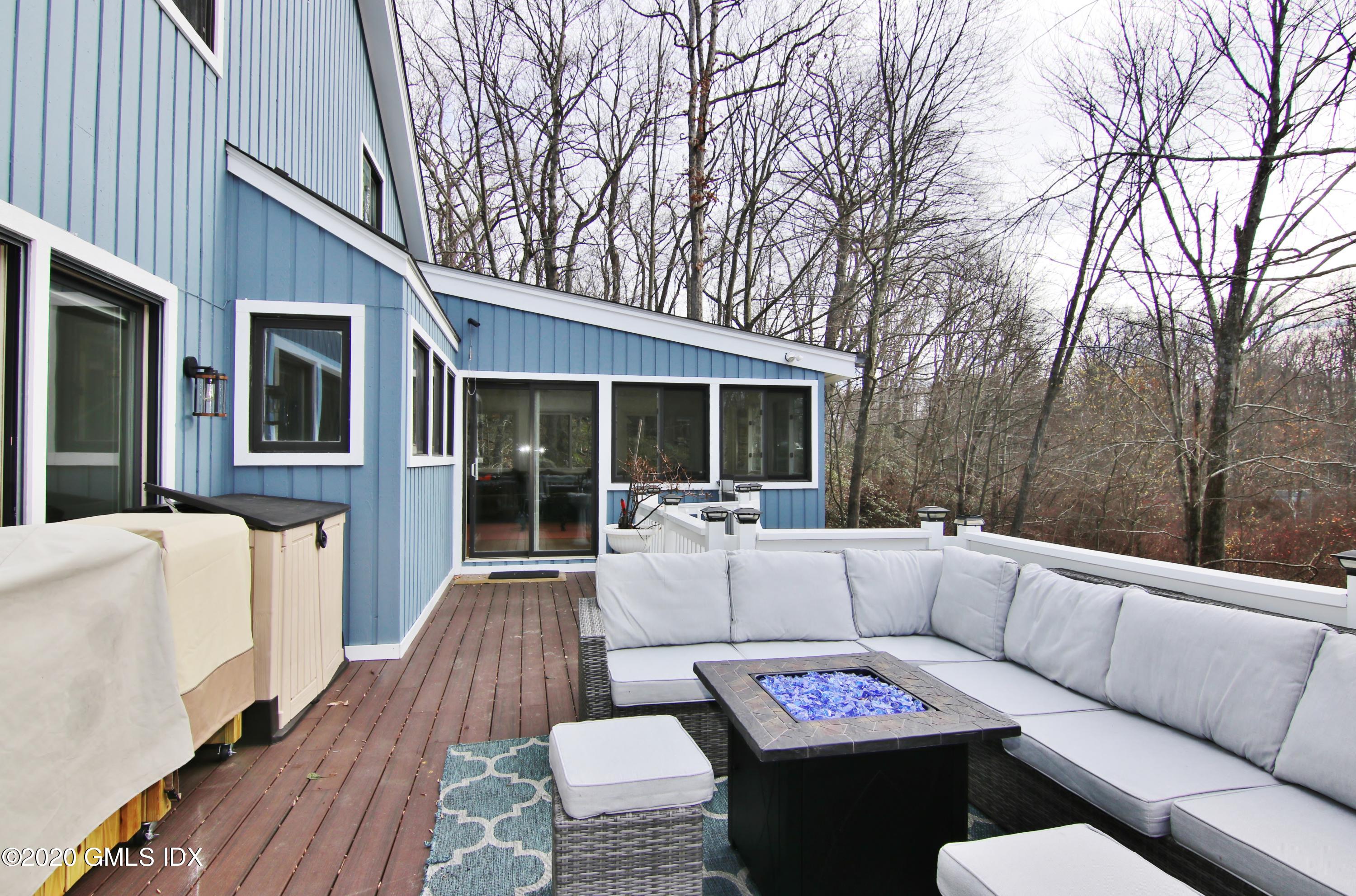 102 Gun Club Road Stamford, CT 06903 - Photo 18 of 41 a view of a house with a couches and wooden floor