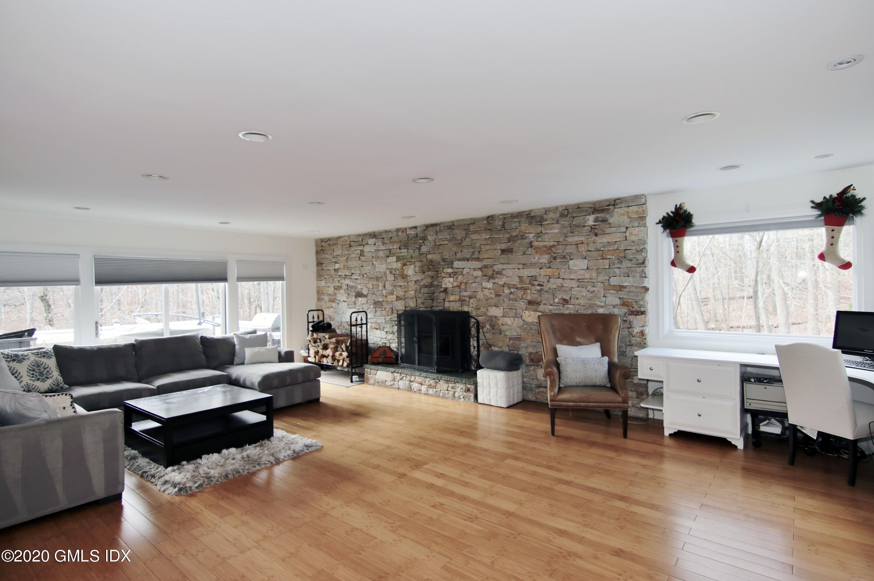 102 Gun Club Road Stamford, CT 06903 - Photo 19 of 41 a living room with furniture and a fireplace