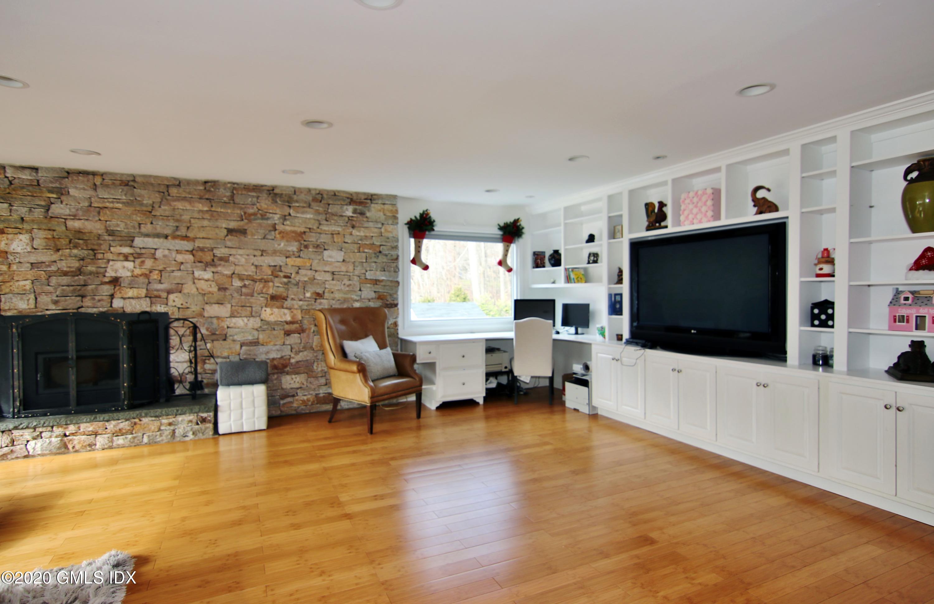 102 Gun Club Road Stamford, CT 06903 - Photo 20 of 41 a living room with furniture and a flat screen tv