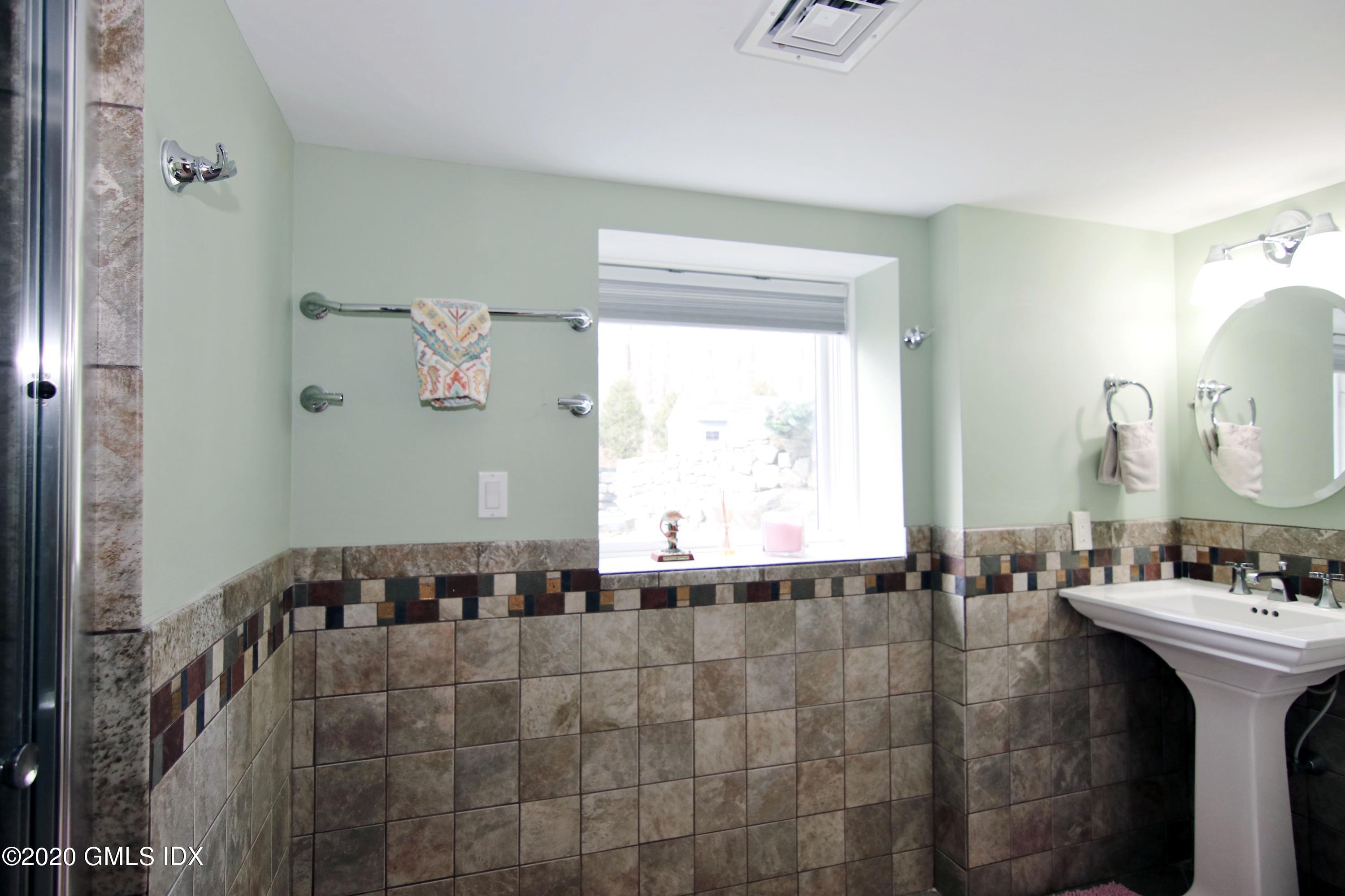 102 Gun Club Road Stamford, CT 06903 - Photo 38 of 41 a bathroom with a bathtub and a sink