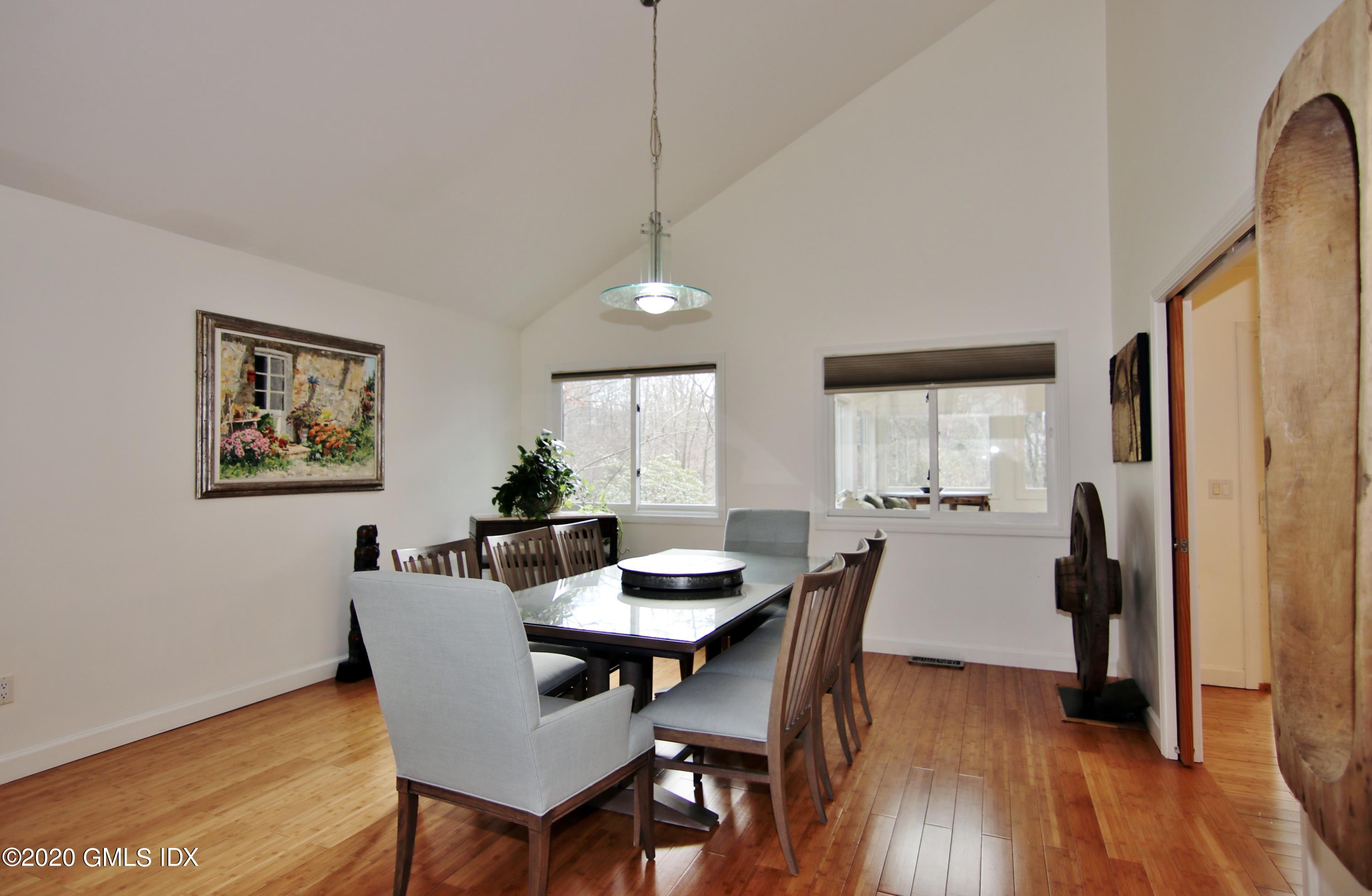 102 Gun Club Road Stamford, CT 06903 - Photo 8 of 41 a view of a dining room with furniture and wooden floor