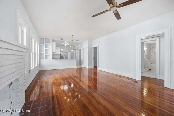 a view of a hallway with wooden floor
