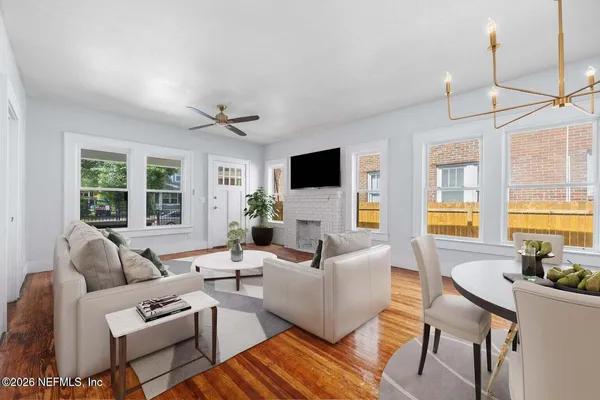 a living room with furniture a wooden floor and a window