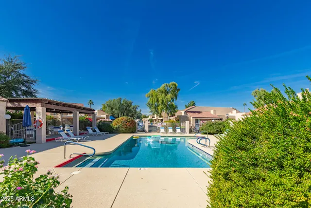 a swimming pool with outdoor seating and yard