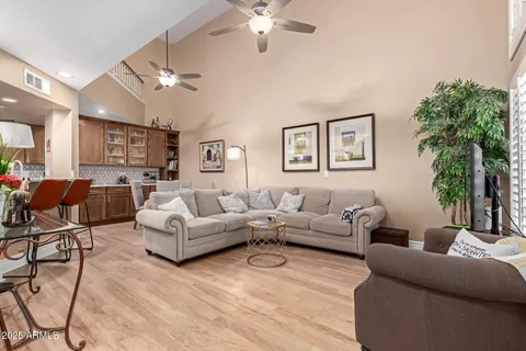 a living room with furniture and a chandelier