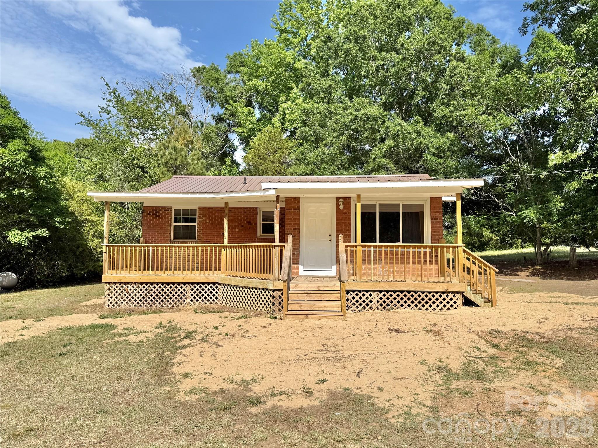 878 Stanback Ferry Road Lilesville, NC 28091 - Photo 1 of 19 a house with trees in the background