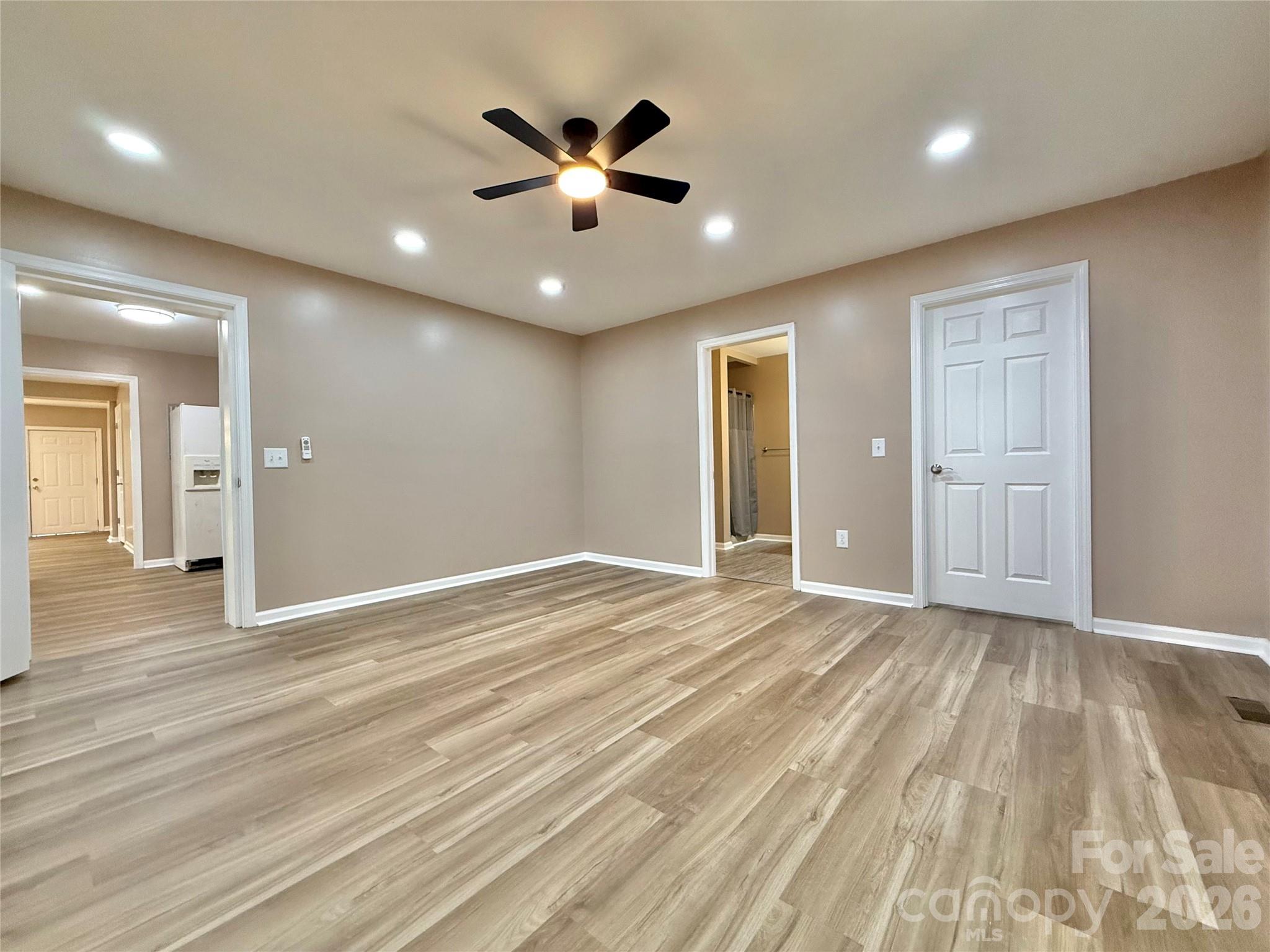 878 Stanback Ferry Road Lilesville, NC 28091 - Photo 12 of 19 an empty room with wooden floor and windows