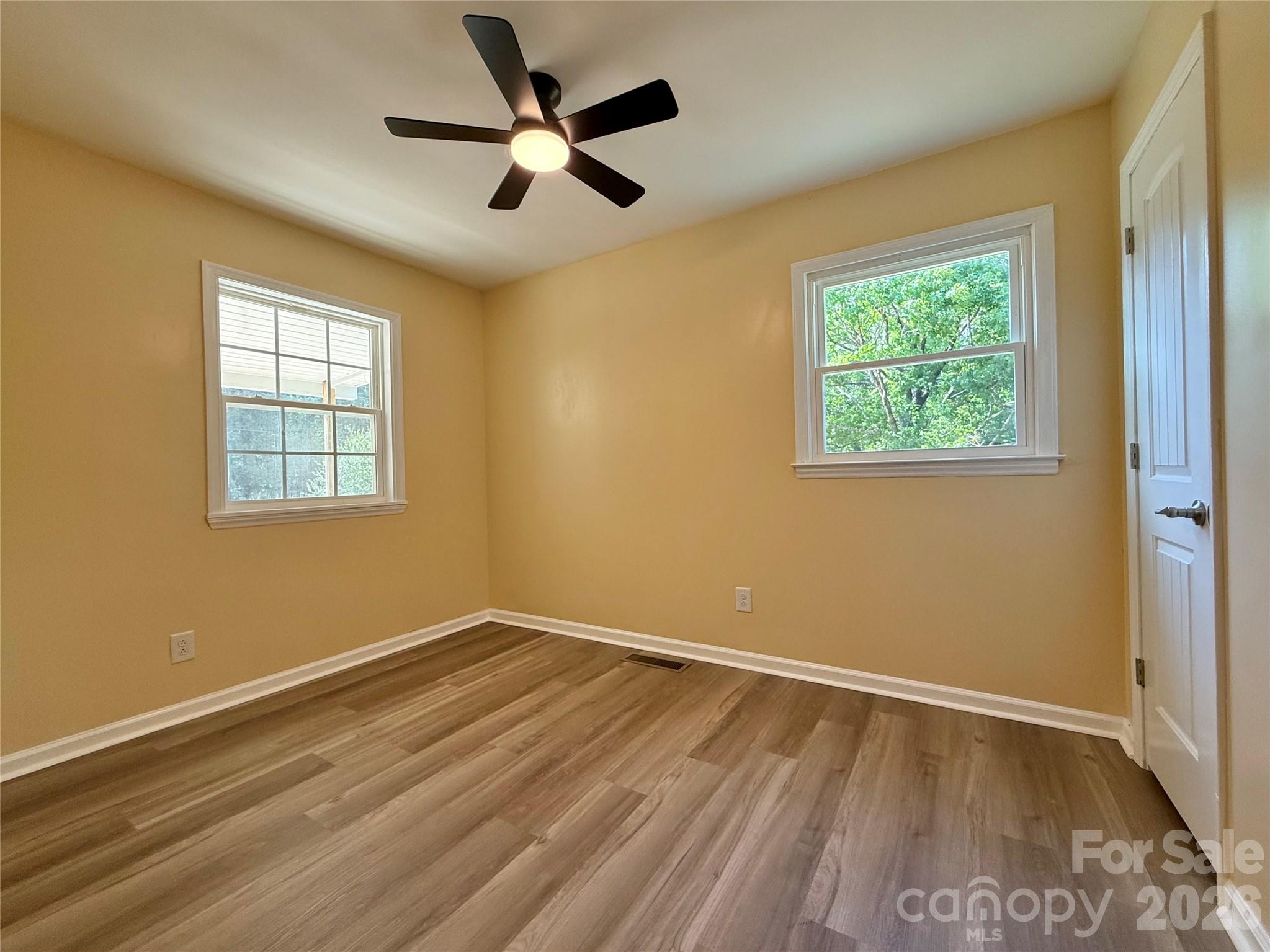 878 Stanback Ferry Road Lilesville, NC 28091 - Photo 16 of 19 a view of empty room with wooden floor and fan
