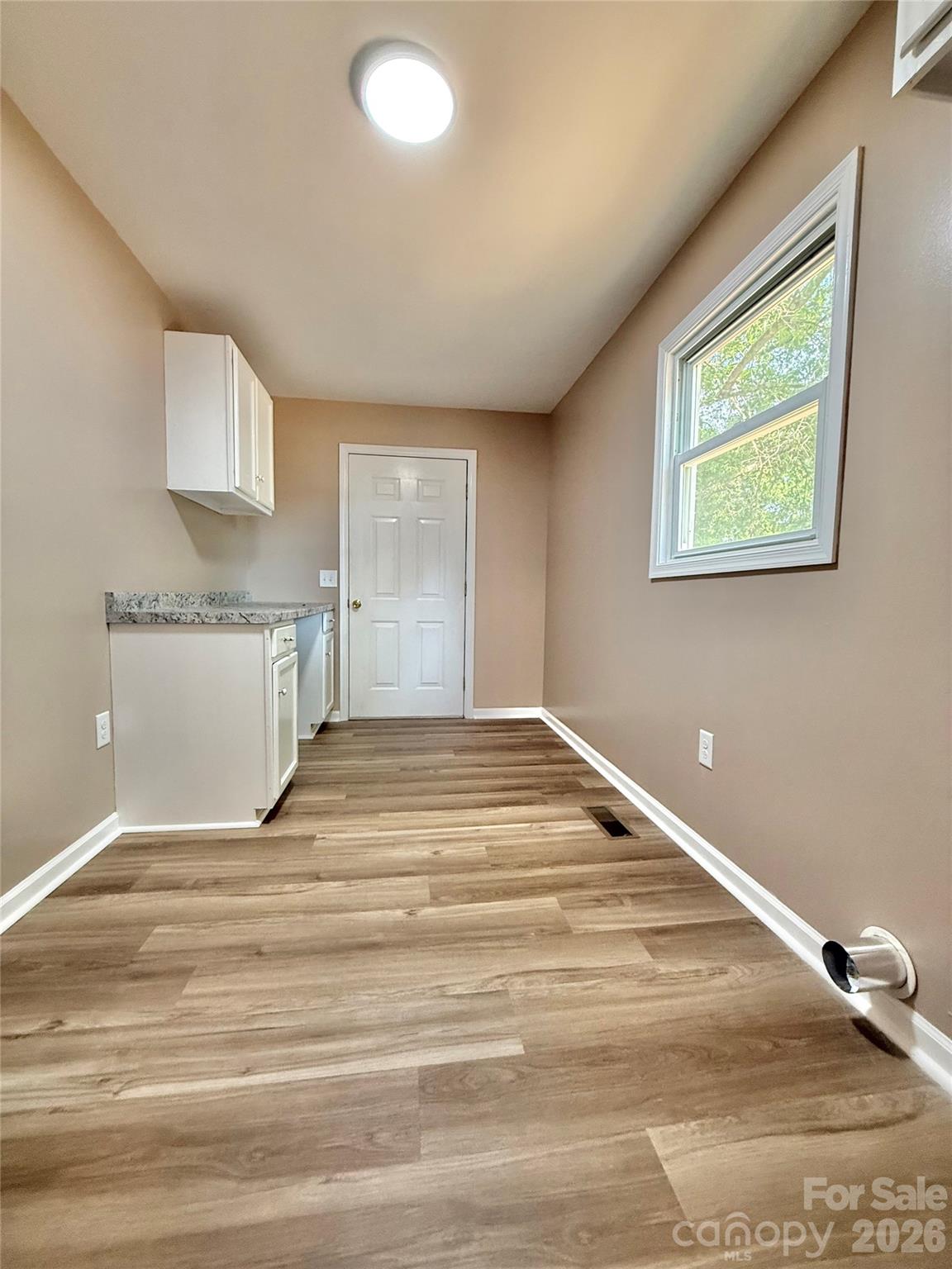 878 Stanback Ferry Road Lilesville, NC 28091 - Photo 19 of 19 a view of a kitchen with wooden floor and a sink