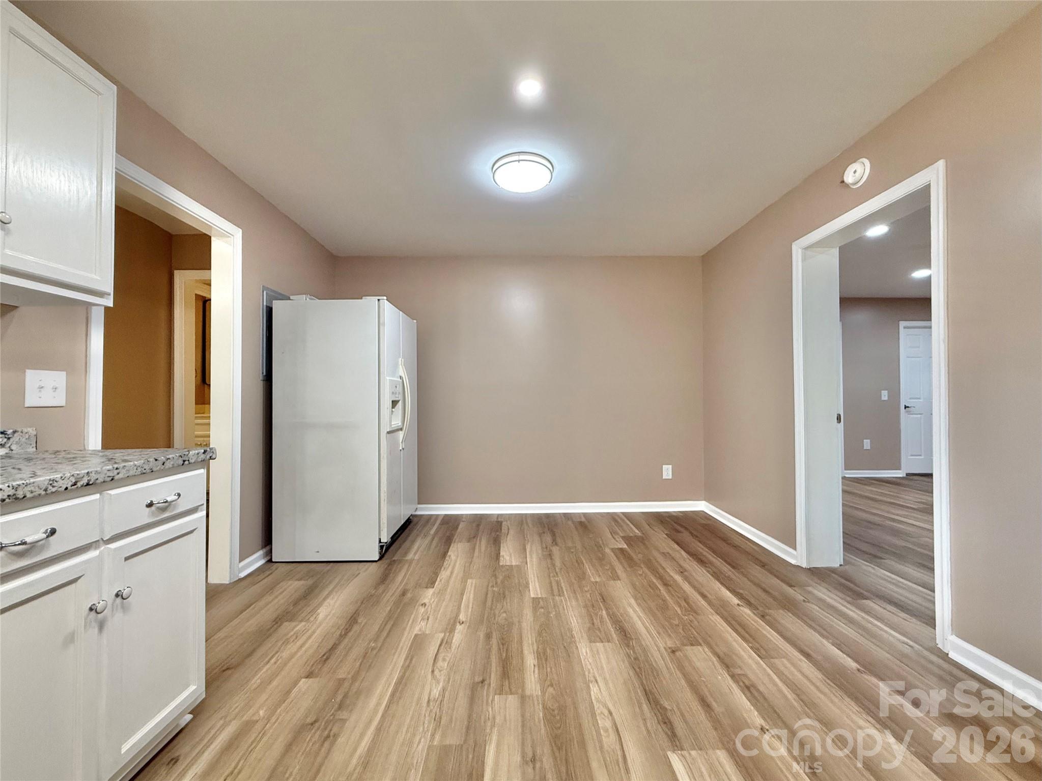 878 Stanback Ferry Road Lilesville, NC 28091 - Photo 10 of 19 a view of a kitchen cabinets a refrigerator and wooden floor