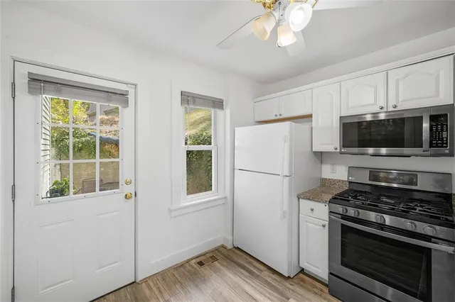 a view of a patio with table and chairs and potted plants