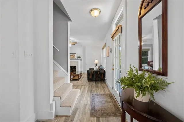 a view of a hallway with wooden floor and staircase