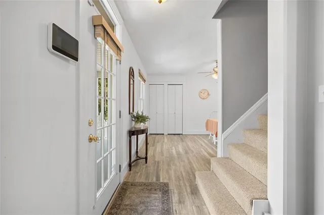 a kitchen with stainless steel appliances granite countertop a sink a stove a refrigerator a microwave oven with cabinets and wooden floor