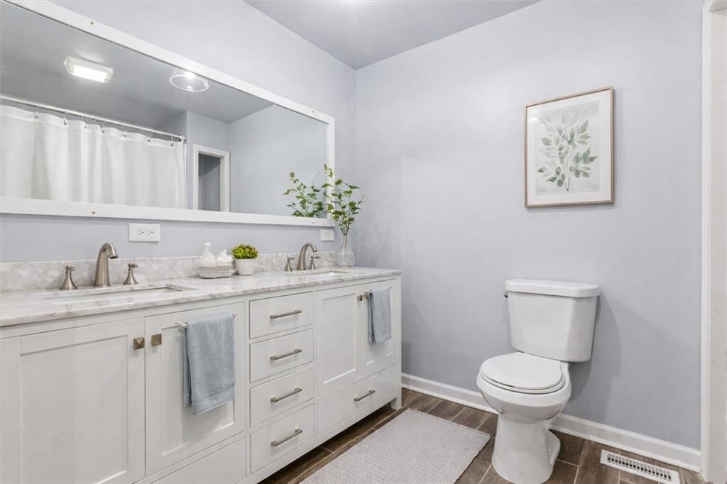 1500 Moores Ferry Road Southwest Plainville, GA 30733 - Photo 10 of 33 a spacious bathroom with a granite countertop toilet sink and mirror