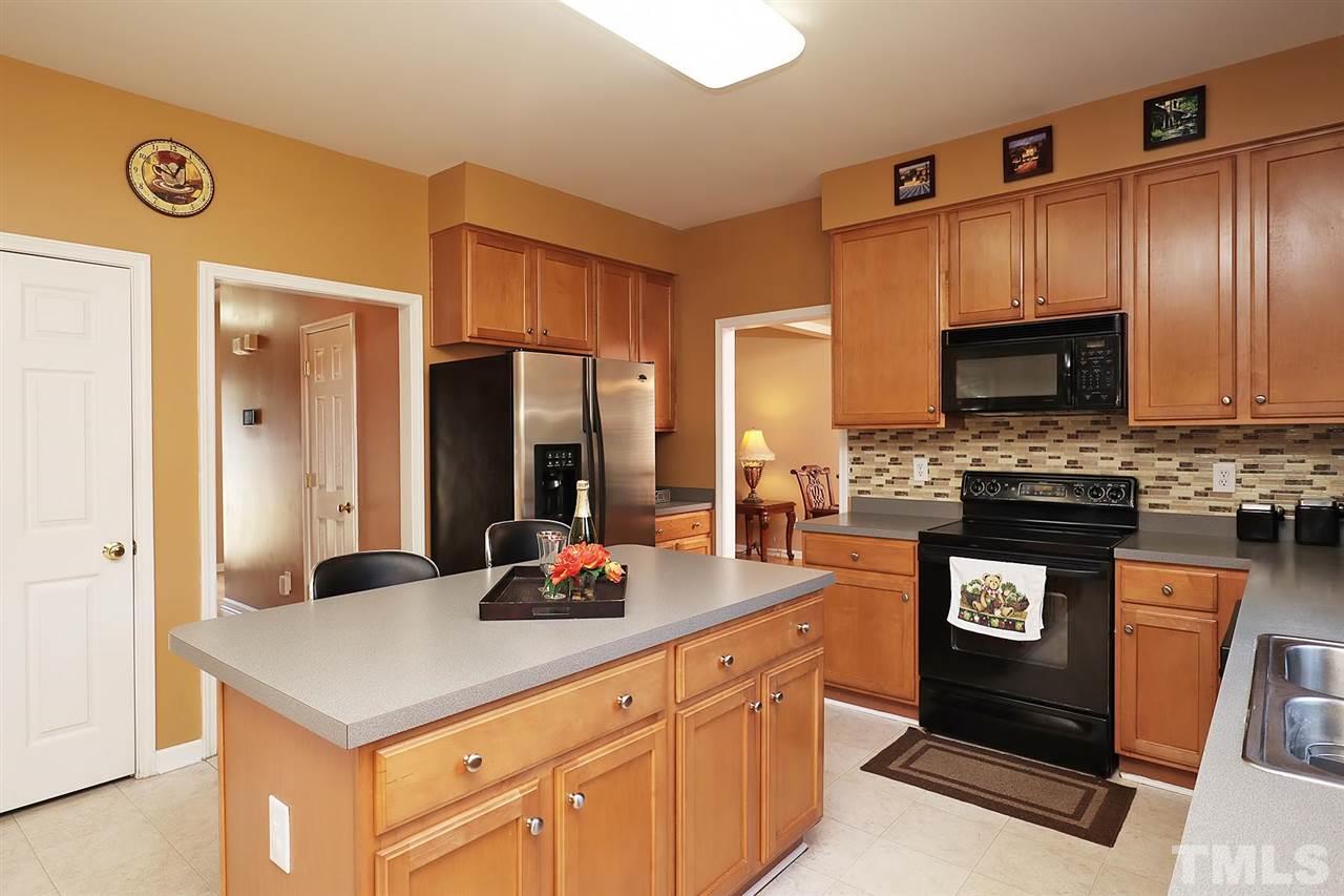 2616 Dality Drive Raleigh, NC 27604 - Photo 11 of 25 a kitchen with stainless steel appliances granite countertop a stove a sink and a refrigerator