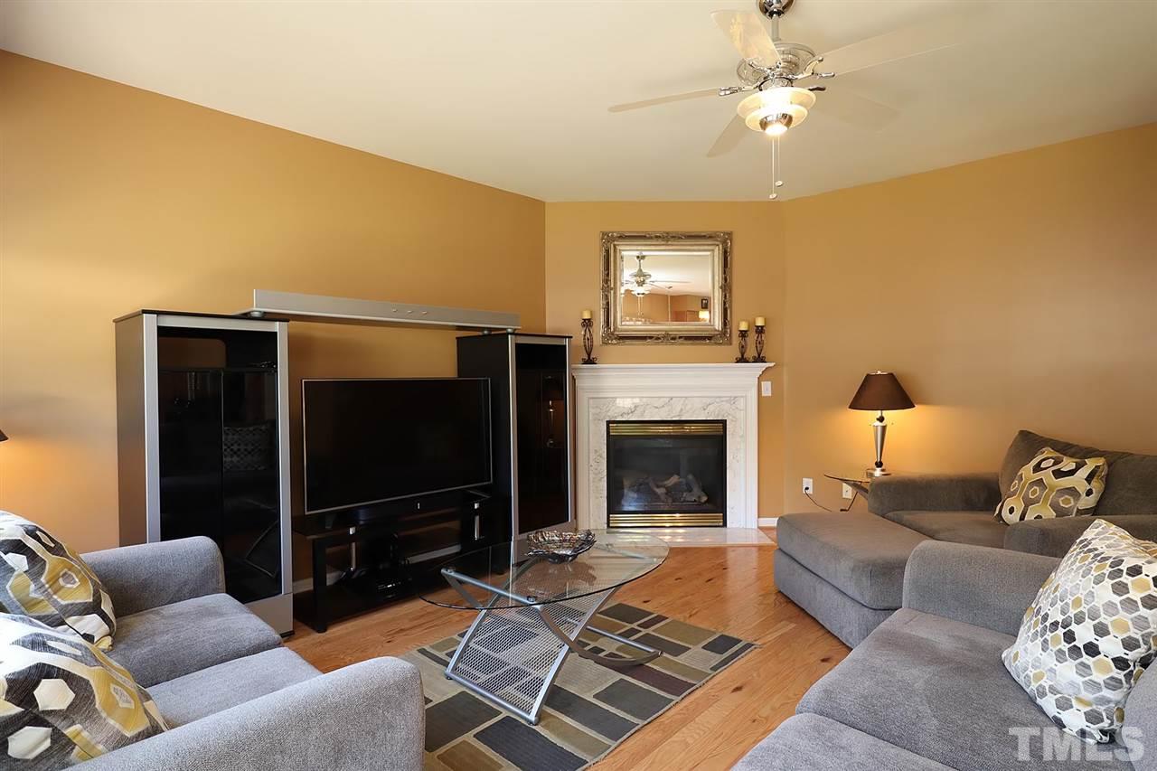 2616 Dality Drive Raleigh, NC 27604 - Photo 14 of 25 a living room with furniture a flat screen tv and a fireplace