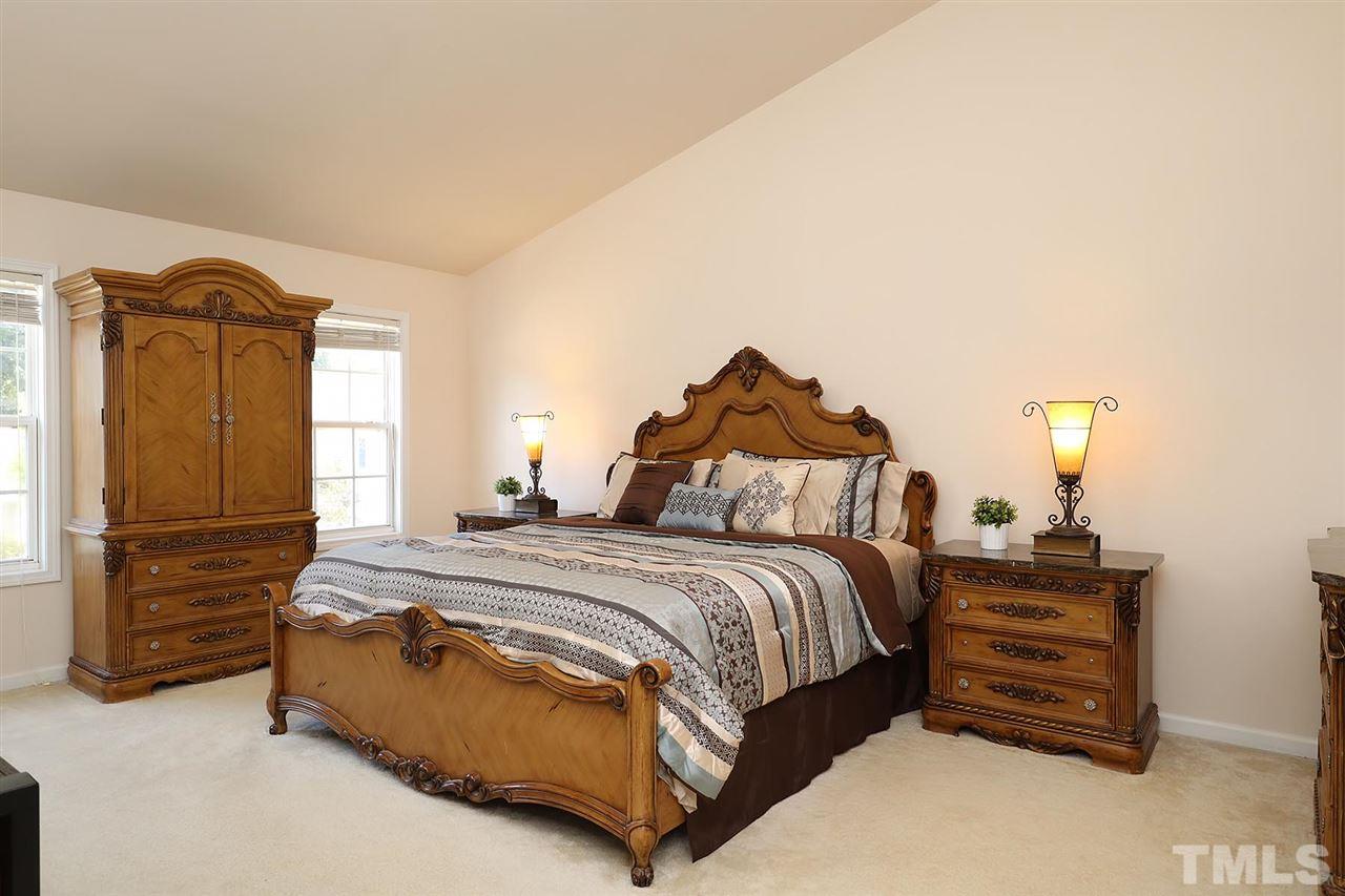 2616 Dality Drive Raleigh, NC 27604 - Photo 18 of 25 a spacious bedroom with a bed dresser and a window