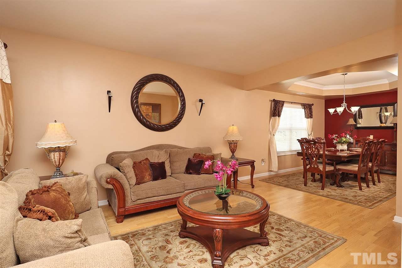 2616 Dality Drive Raleigh, NC 27604 - Photo 5 of 25 a living room with furniture a rug and a large window