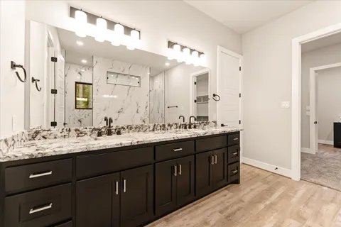 a bathroom with a sink double vanity and a mirror