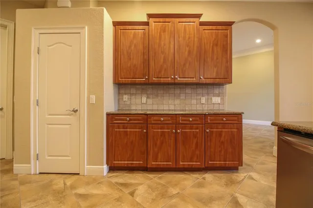 a view of a kitchen with wooden cabinets