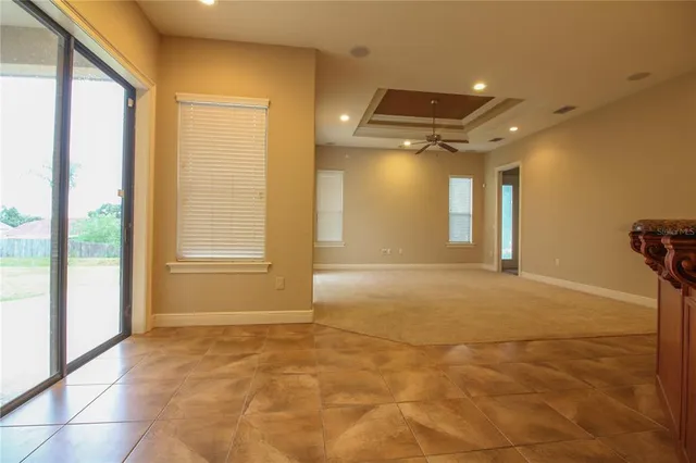 a view of an empty room with a fireplace and a window