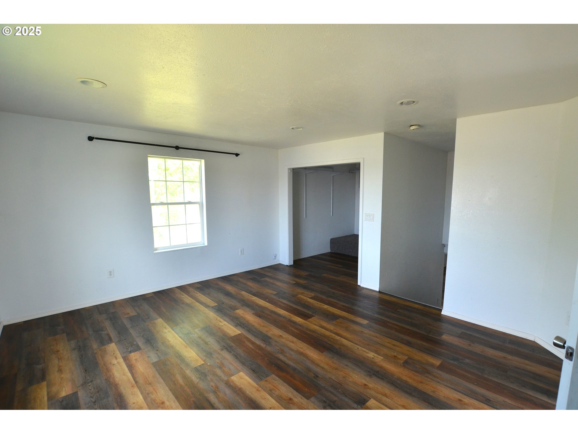 520 Northeast 4th Street Pilot Rock, OR 97868 - Photo 21 of 28 a view of an empty room with wooden floor and a window