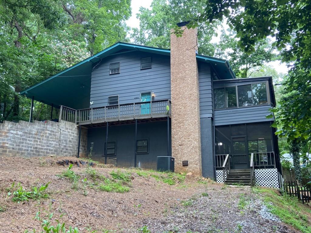 4384 Marjorie Road Southwest Snellville, GA 30039 - Photo 1 of 1 a front view of a house with garden