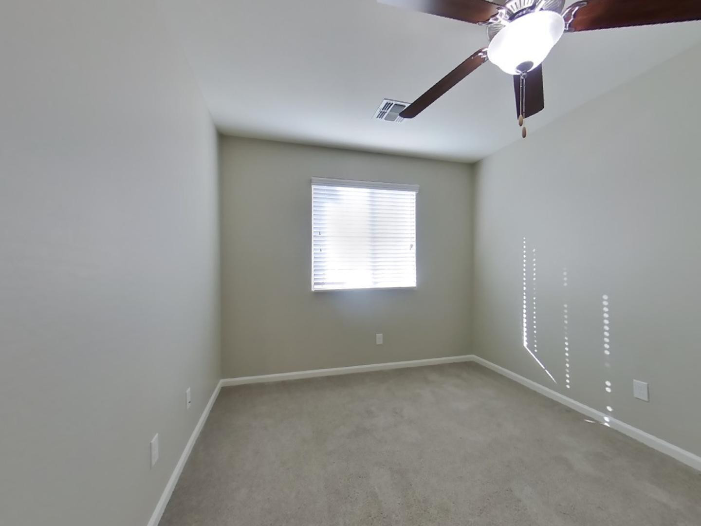 12565 West Via Dona Road Peoria, AZ 85383 - Photo 13 of 17 an empty room with a window and a fan