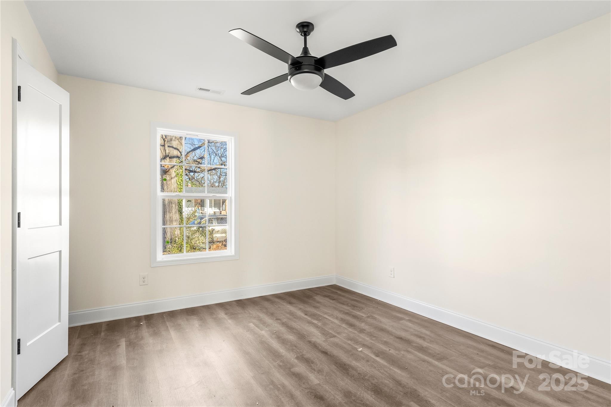 545 Washington Street Rock Hill, SC 29730 - Photo 14 of 25 an empty room with wooden floor and ceiling fan