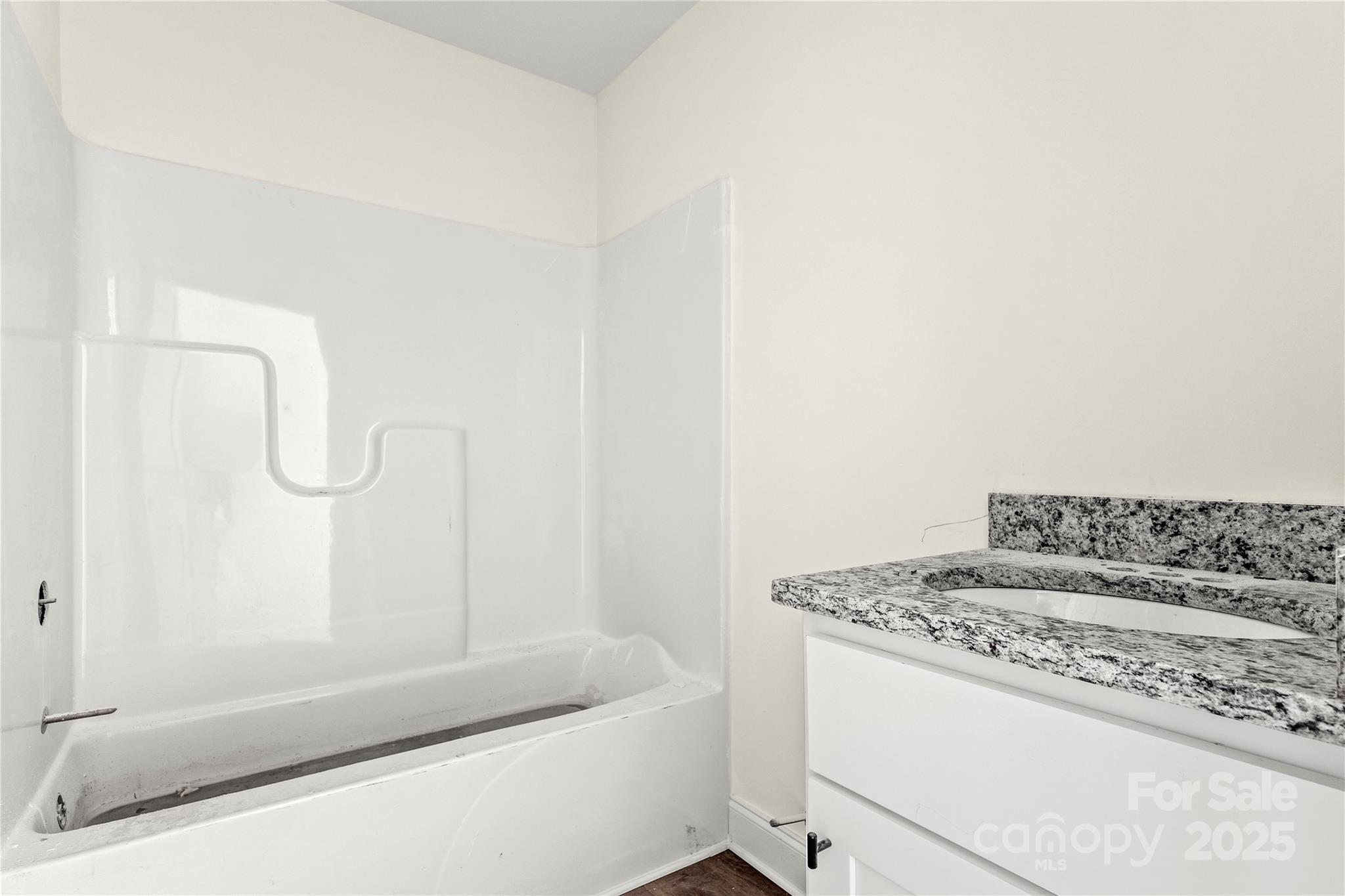 545 Washington Street Rock Hill, SC 29730 - Photo 18 of 25 a bathroom with a granite countertop sink and a bathtub