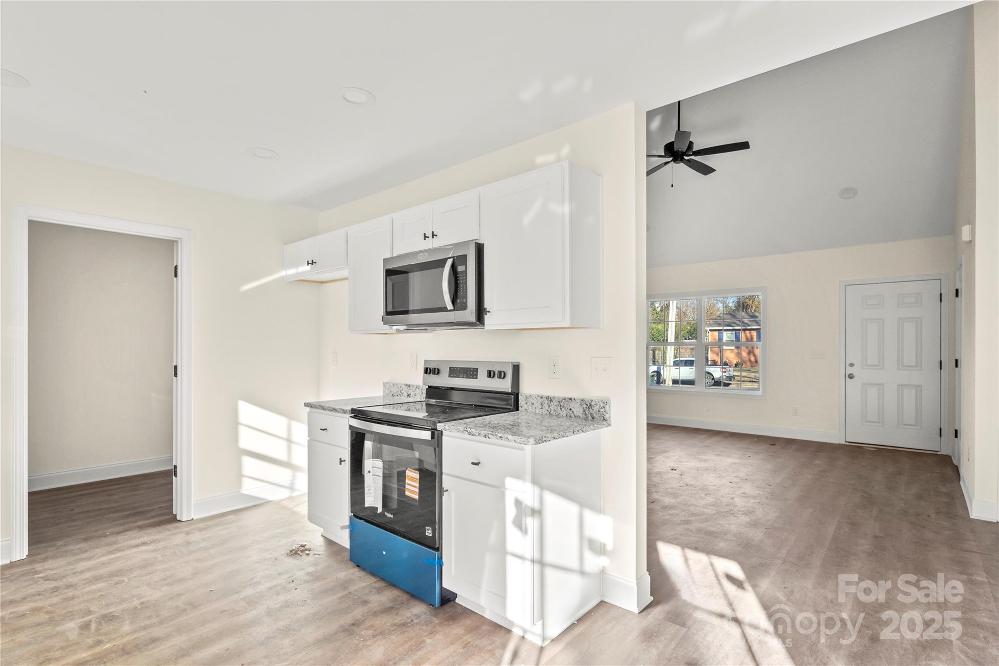545 Washington Street Rock Hill, SC 29730 - Photo 8 of 25 a kitchen with stainless steel appliances granite countertop a stove a sink and a refrigerator
