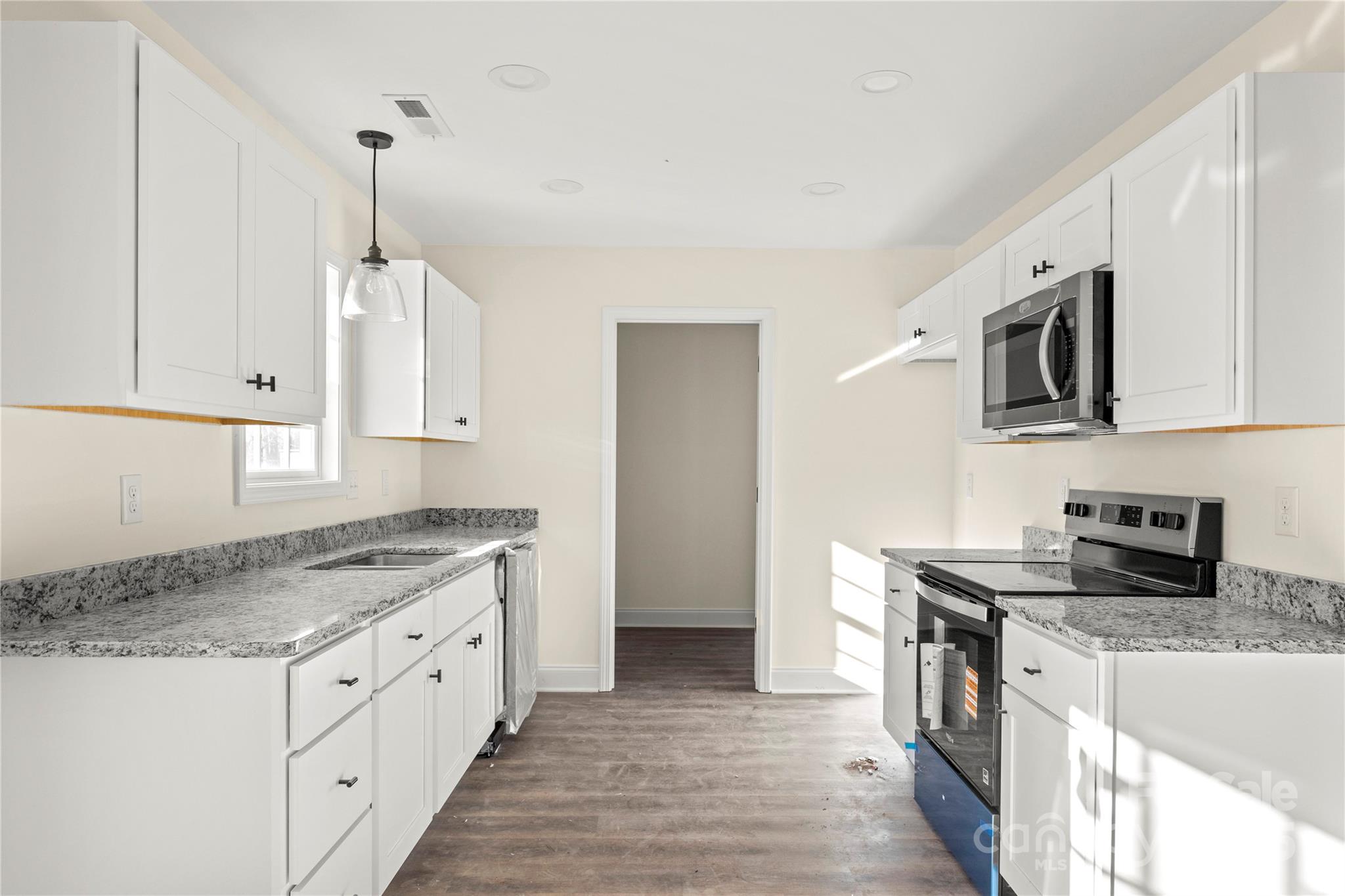 545 Washington Street Rock Hill, SC 29730 - Photo 9 of 25 a kitchen with stainless steel appliances granite countertop a sink stove and microwave