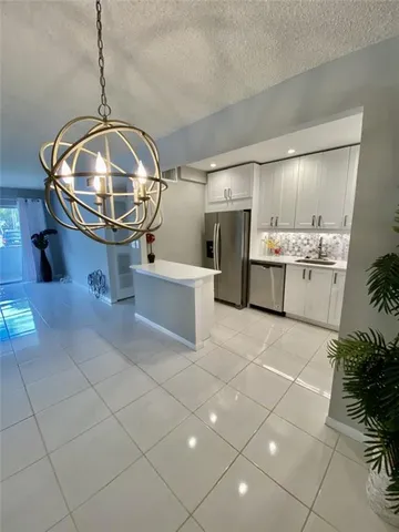 a room with gym equipment and view of living room